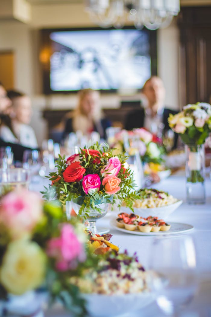 Beautiful dining setup with vibrant floral arrangements and gourmet dishes, perfect for celebrations.